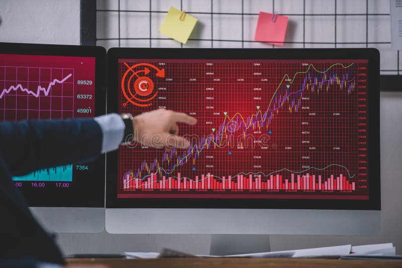 Cropped view of computer systems analyst pointing with finger at graphs stock images