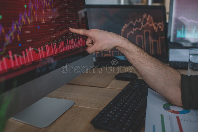 Cropped view of data analyst pointing on charts stock photo