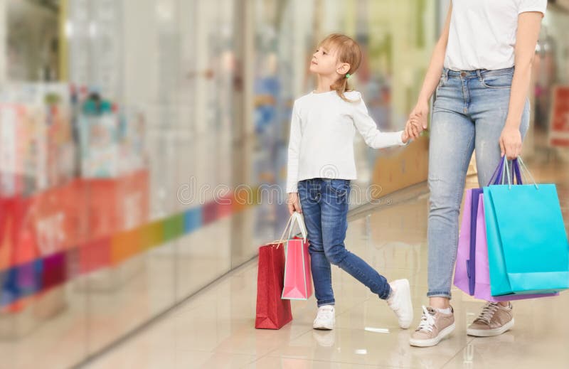 Funny girl keeping hand of mother in bag mall stock images Funny girl keeping hand of mother in bag mall stock images