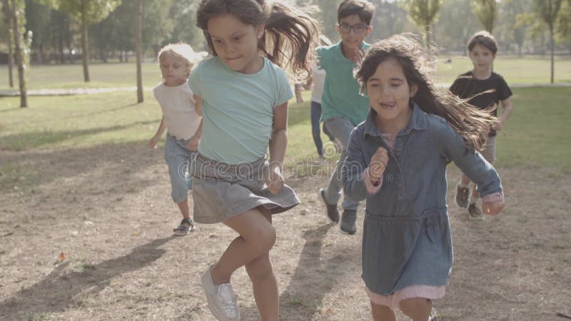 Cropped view of happy children running together and smiling