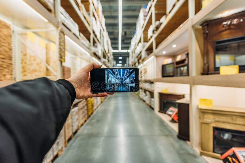 Cropped view of person taking photo of storage on smartphone Camera point stock images