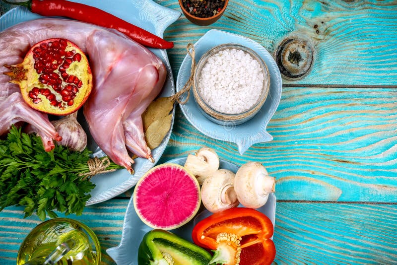 Cropped view of Raw whole rabbit with vegetables on rustic background. free space for text stock photo Cropped view of Raw whole rabbit with vegetables on rustic background. free space for text stock photo