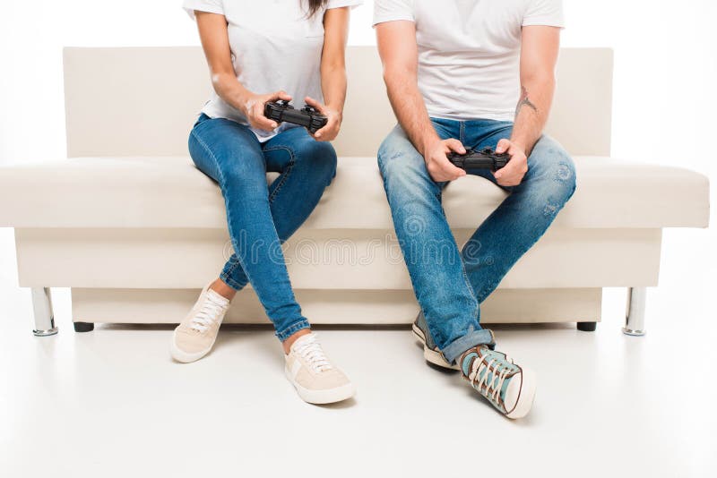 Young Cute Competitive Boyfriend Girlfriend Playing Video Games In Couch  Stock Photo, Picture and Royalty Free Image. Image 34313215.