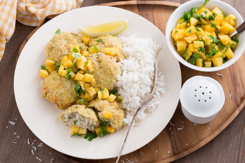 Fish cakes with mango salsa and white rice, top view, horizontal. Fish cakes with mango salsa and white rice, top view, horizontal