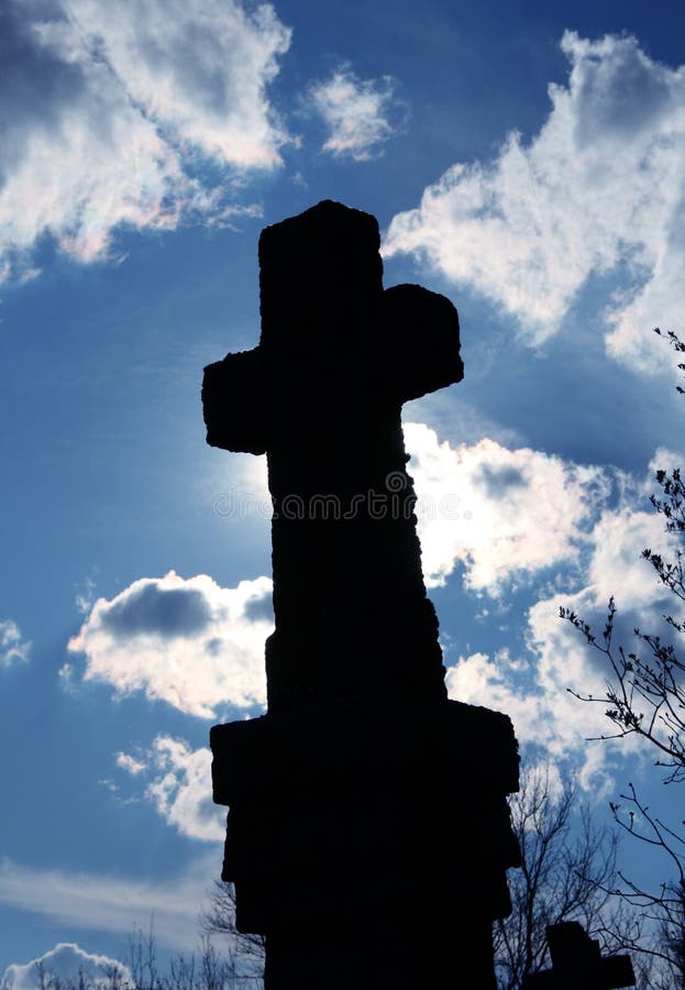 Stone cross silhouette and sky detail