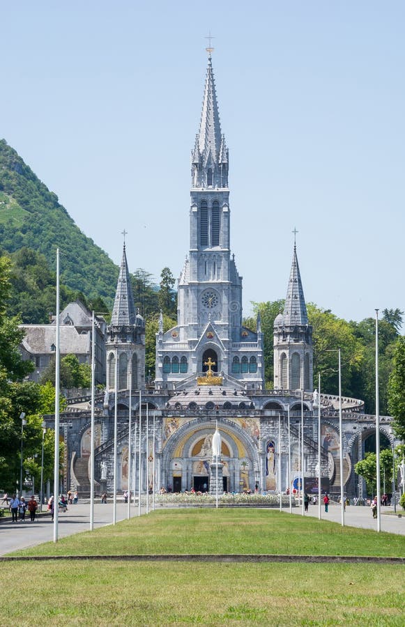 Cross and the Basilica of the Holy Rosary in Lourdes, France. Main ...