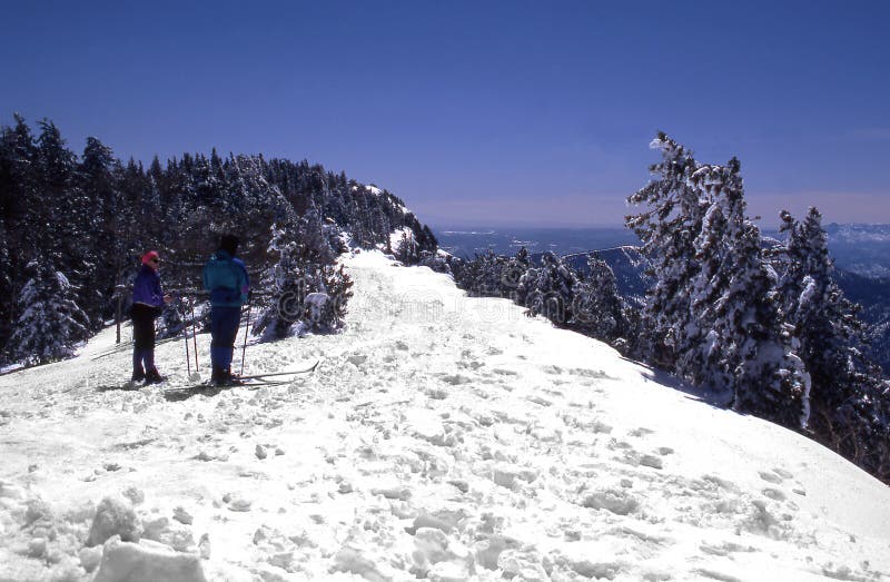 Cross country skiers on top of sandia mountain enjoying the view