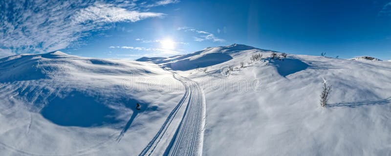 Cross country skiing slope running though stunning snow covered landscape.