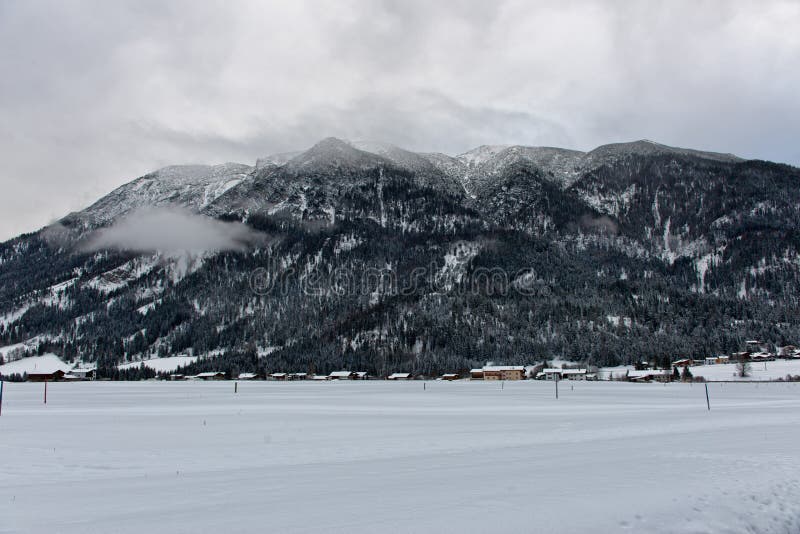 Cross country skiing resort in Achenkirch, Austria with beautiful large mountain in background under overcast sky. Cross country skiing resort in Achenkirch, Austria with beautiful large mountain in background under overcast sky