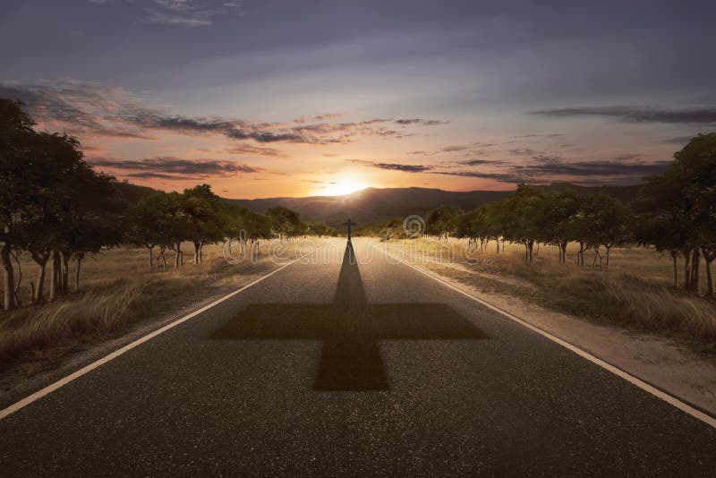 Cross at the end of the road with his shadow