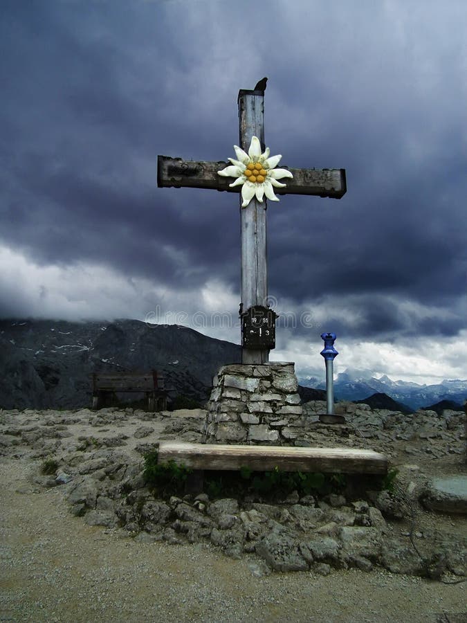 Kehlsteinhaus. The cross near the tea house of Hitler. Raven on a cross in gloomy weather