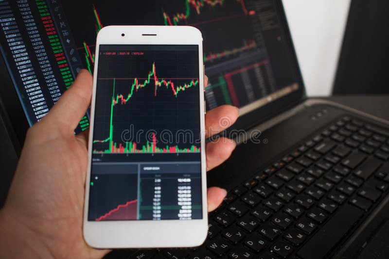 Cross-platform services for investments in cryptocurrency. The user monitors the securities market royalty free stock image