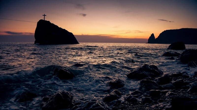 Cross on a rock in the sea, on the coast