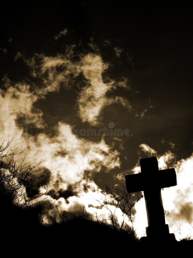 Cross silhouette with clouds_in backlight