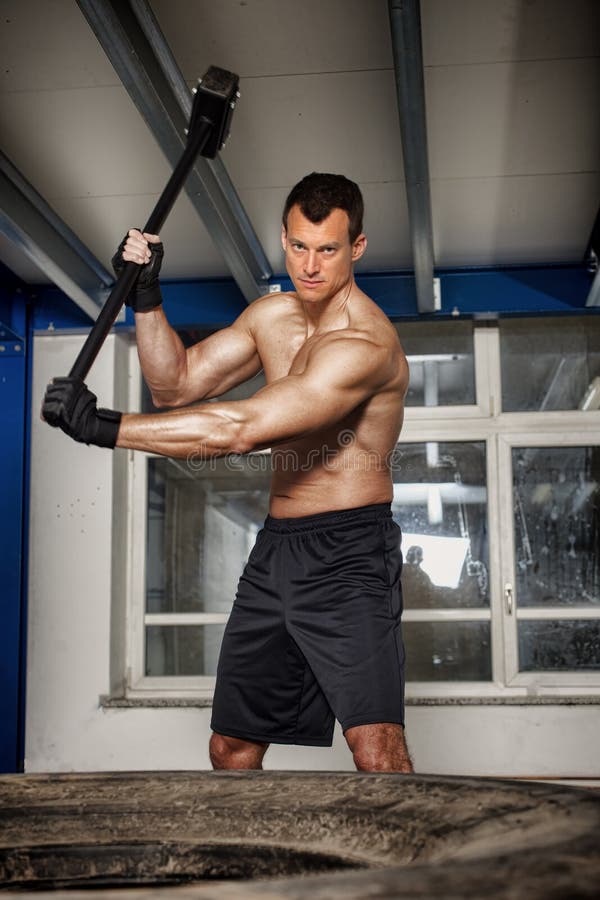 Crossfit Man Throwing Hammer on Tire Stock Photo Image of heavy