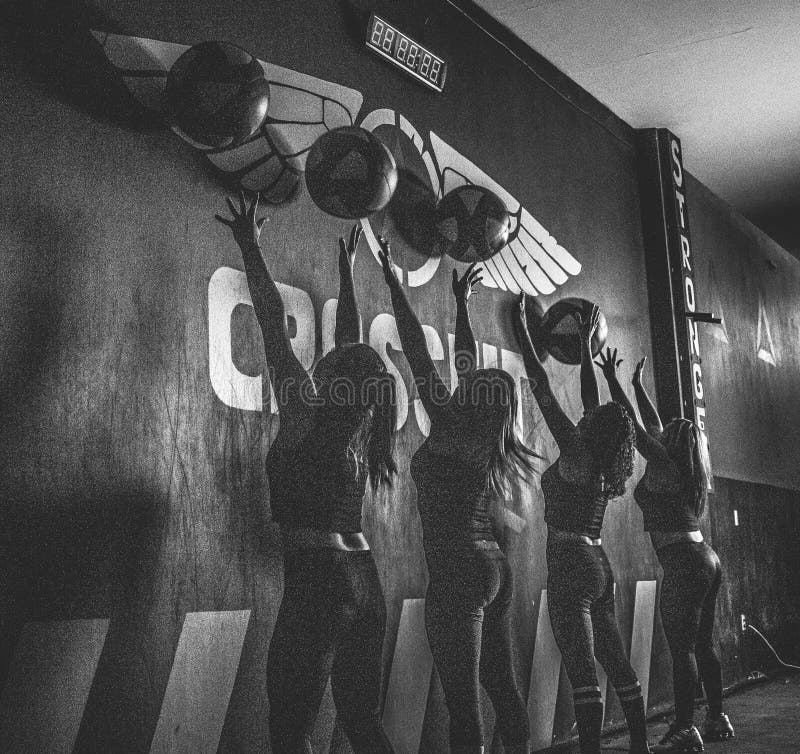 Crossfitters training hard daily wod silouettes black and white royalty free stock photography Crossfitters training hard daily wod silouettes black and white royalty free stock photography