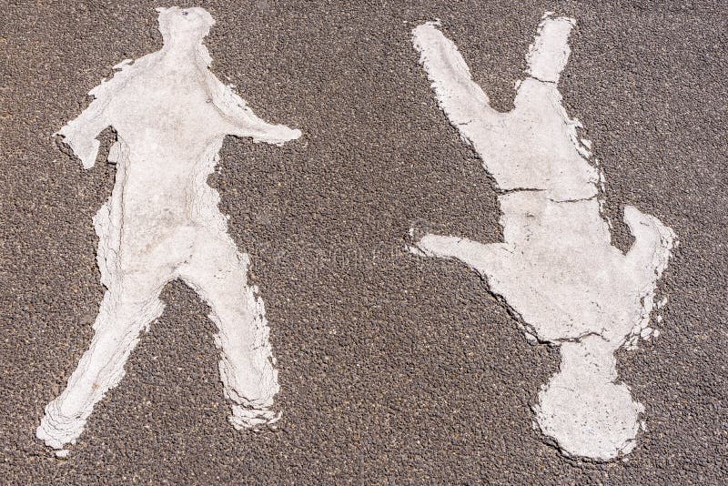 Two faded painted human figures on a footpath stock photography
