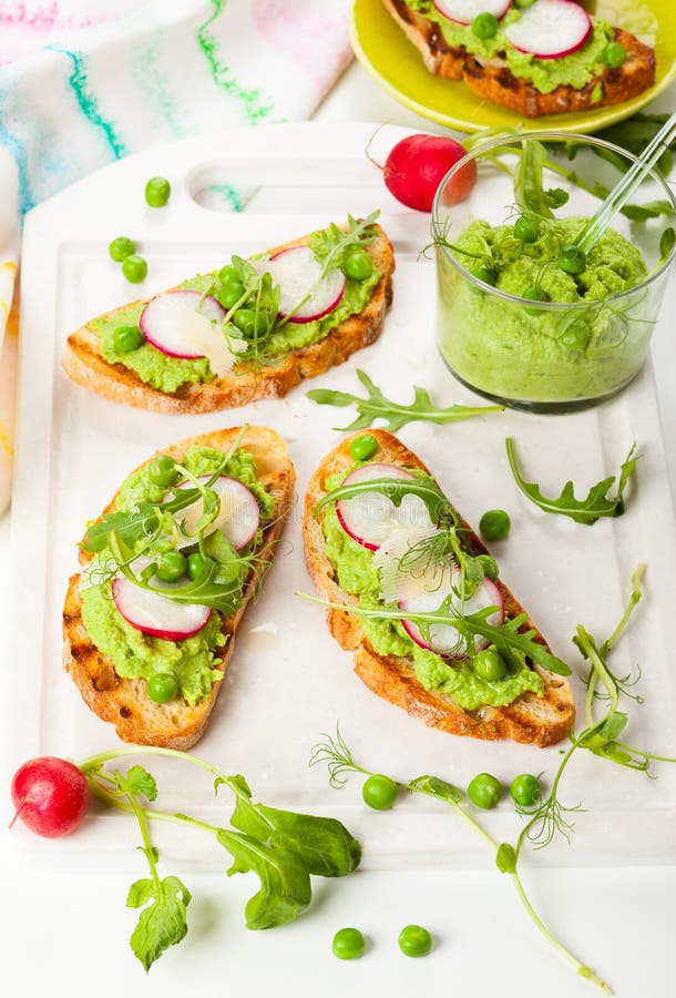 Crostini with pea puree,radish,rocket and cheese. Crostini with pea puree,radish,rocket and cheese