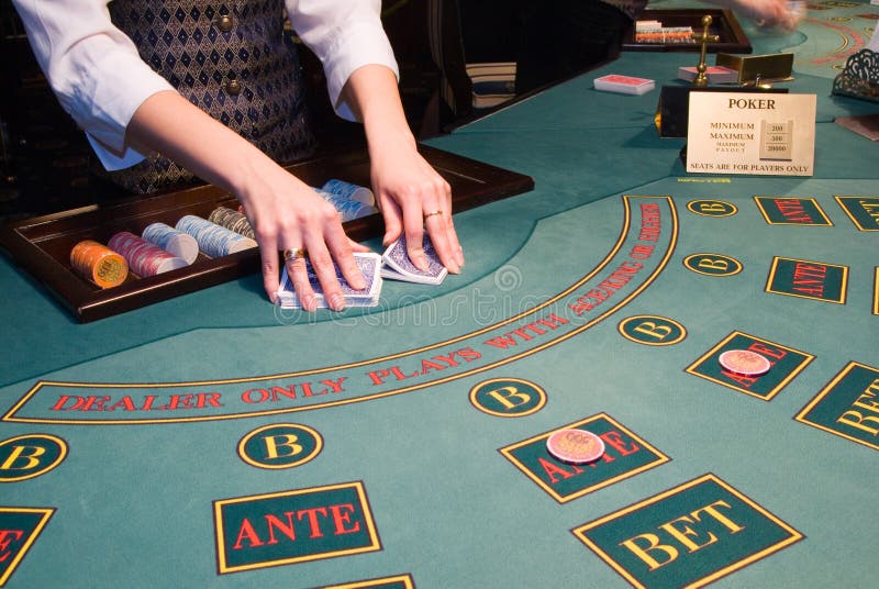 Croupier shuffling playing cards at poker table stock images Croupier shuffling playing cards at poker table stock images