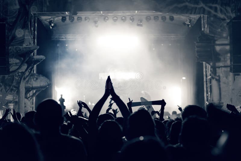 Crowd at a Music Concert, Audience Raising Hands Up, Toned Stock Photo