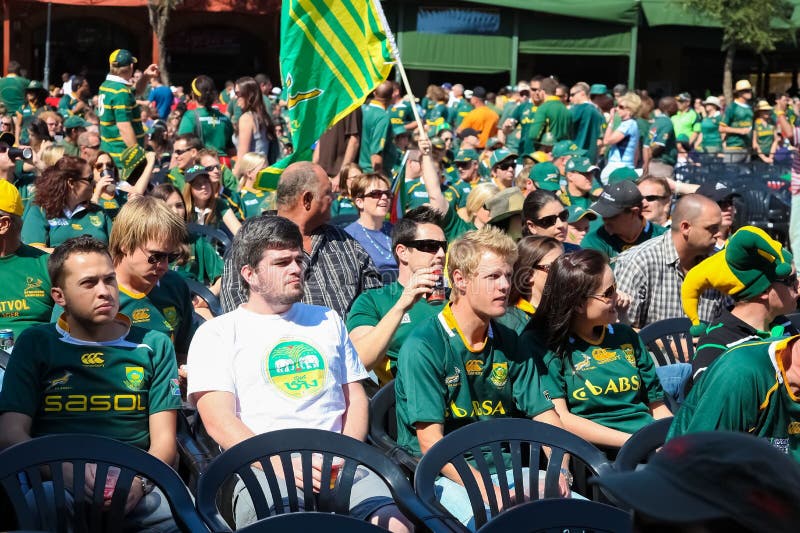 Crowd of People in Green Jerseys Seated for a Rugby Event Editorial