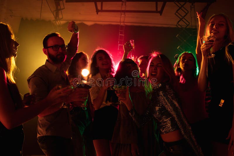 A Crowd of People in Silhouette Raises Their Hands on Dancefloor on ...