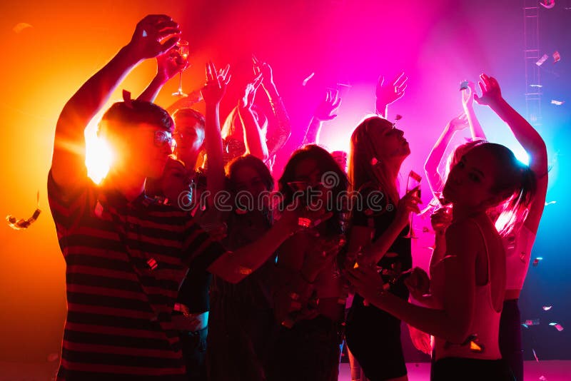 A Crowd of People in Silhouette Raises Their Hands on Dancefloor on ...