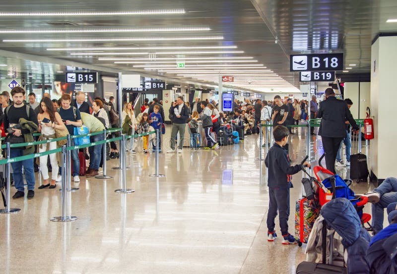 Crowd of people waiting in line to check in at an airport