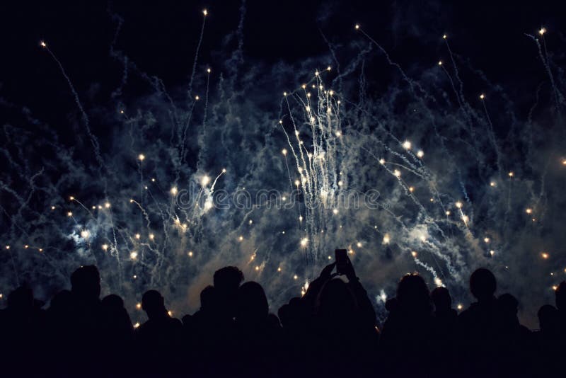 Crowd of Silhouetted People Watching a Fireworks Display and Concert stock photo Crowd of Silhouetted People Watching a Fireworks Display and Concert stock photo