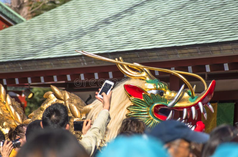 Crowd taking photos of a golden dragon in the Sensoji temple of Asakusa.