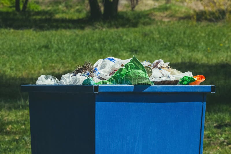 A Crowded Blue Trash Can on the Street. Stock Image Image of blue