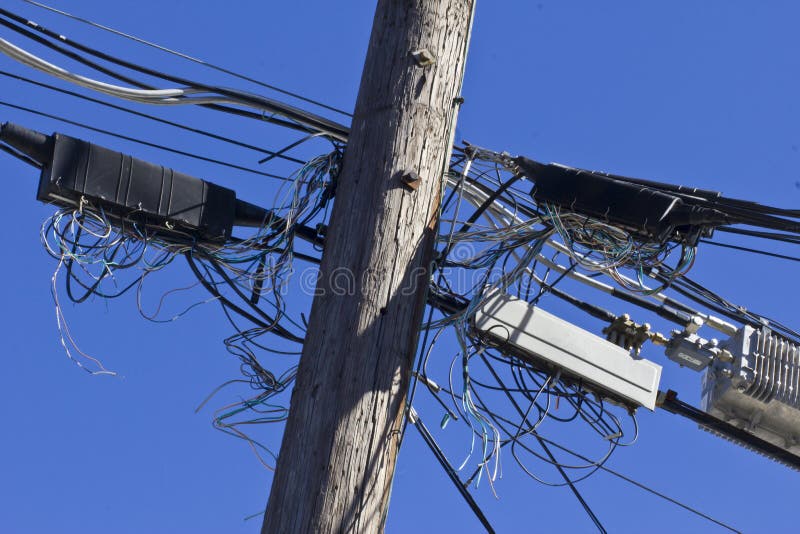 Crowded Telephone Poles With Tangled Lines Representing Old Technology