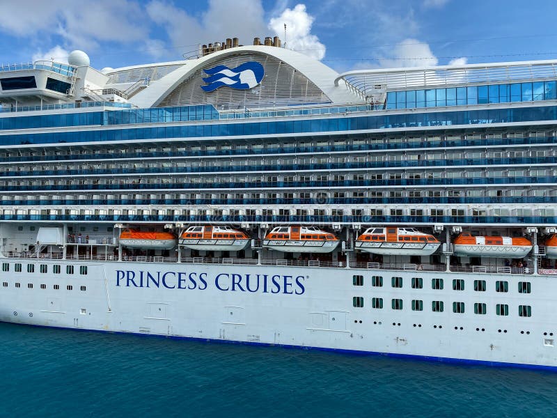 The Crown Princess cruise ship, is owned by Carnival Corporation, docked at Aruba on a sunny day with blue skies royalty free stock photos The Crown Princess cruise ship, is owned by Carnival Corporation, docked at Aruba on a sunny day with blue skies royalty free stock photos