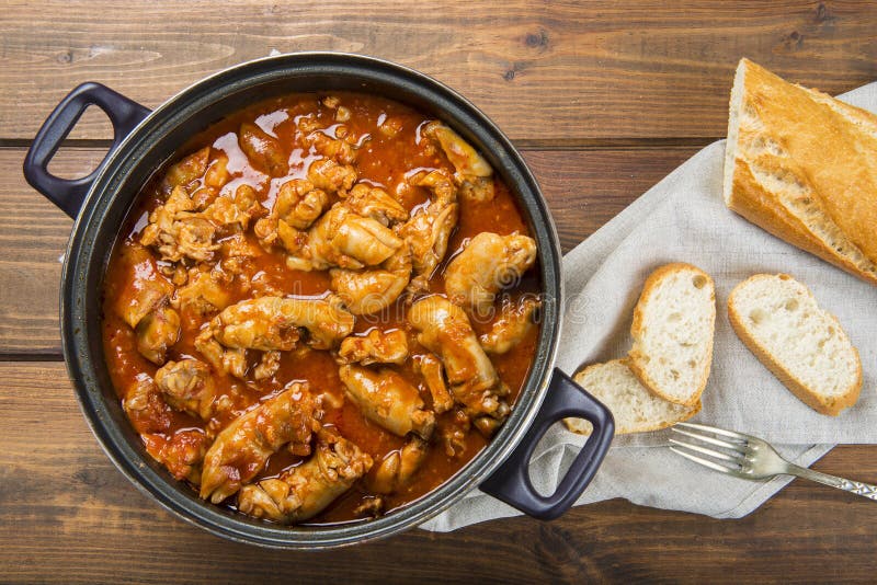 Crubeens with tomato sauce and bread Spanish recipe. Crubeens with tomato sauce and bread Spanish recipe