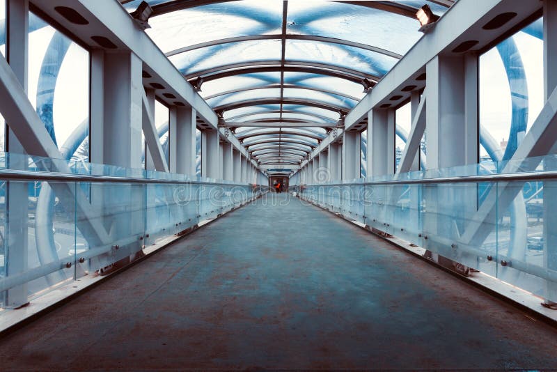 A sky bridge made out of aluminum, plastic and glass for the pedestrians to cross over traffic underneath. A sky bridge made out of aluminum, plastic and glass for the pedestrians to cross over traffic underneath