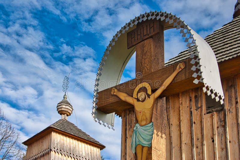 Crucified Christ on the cross in front of church in Korejovce during autumn