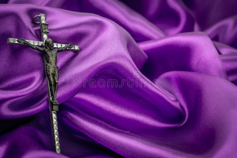 Crucifix on purple background