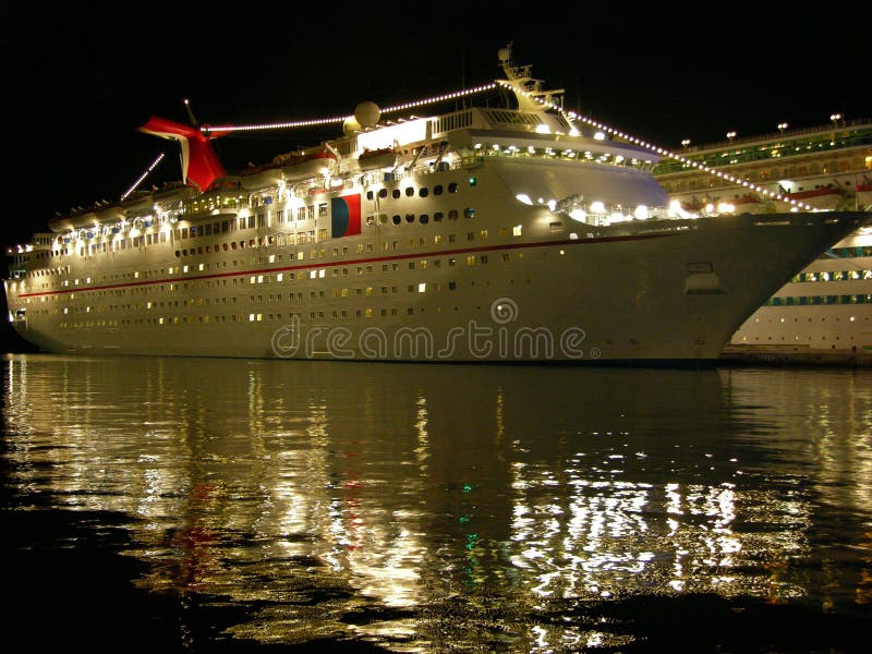 The medium size cruise ship filled with lights at night in Nassau town port, The Bahamas. The medium size cruise ship filled with lights at night in Nassau town port, The Bahamas.