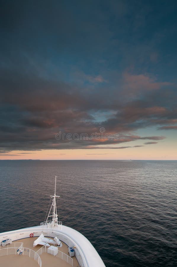 Cruise ship sailing at sunset