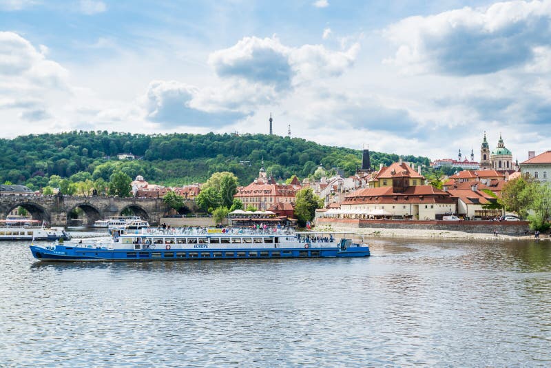 Cruise ship sailing on the Vltava River, with the background of Prague Castle, the world`s largest one in the world royalty free stock image Cruise ship sailing on the Vltava River, with the background of Prague Castle, the world`s largest one in the world royalty free stock image