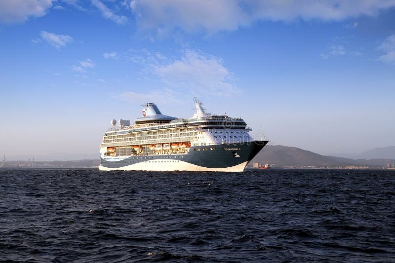 Big cruiseship Tui Discovery 2 sailing inside Algeciras bay and close to the Rock of Gibraltar.