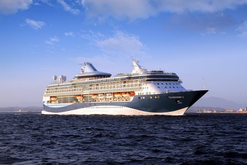 Big cruiseship Tui Discovery 2 sailing inside Algeciras bay and close to the Rock of Gibraltar.