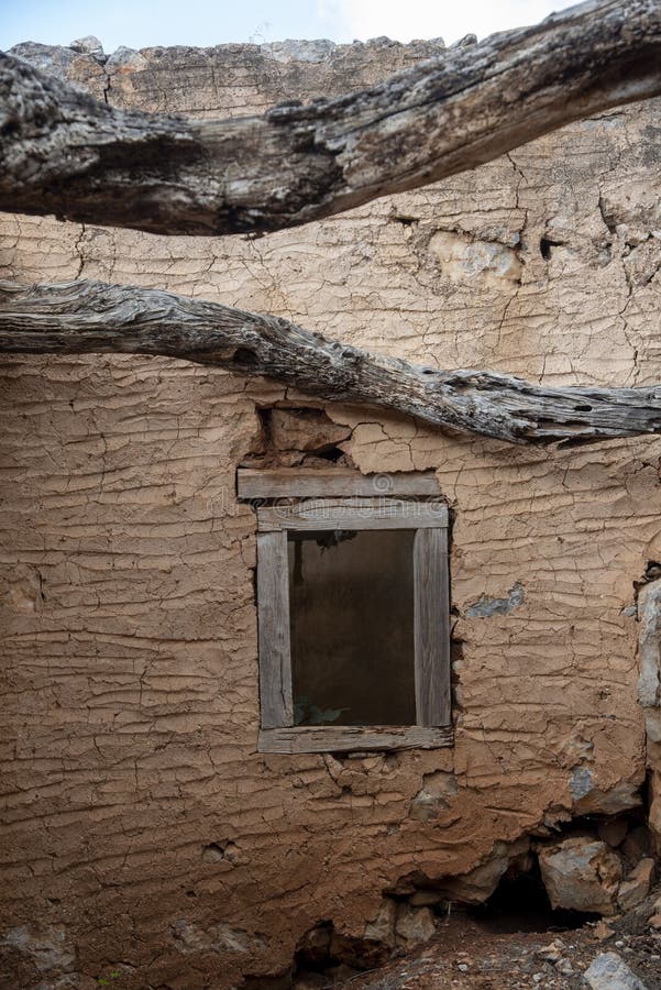 Abandoned stone building reclaimed by nature with trees and weathered walls royalty free stock images