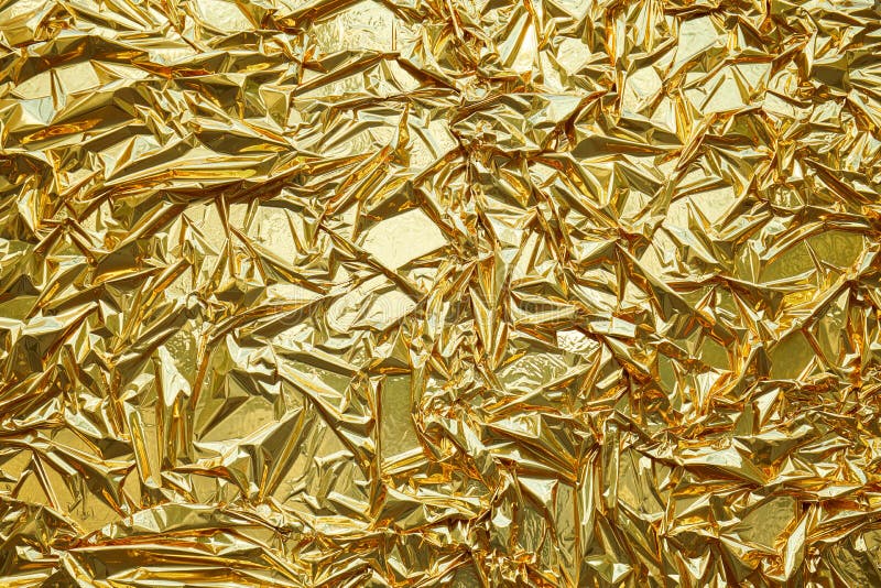 Crumpled, gold metallic foil texture background royalty free stock photography
