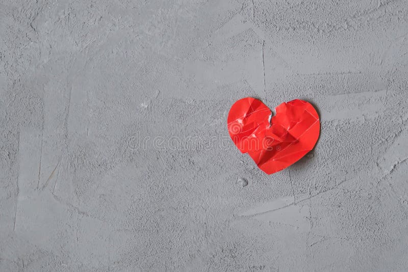 Crumpled Paper Heart On The Concrete Floor Broken Relationships