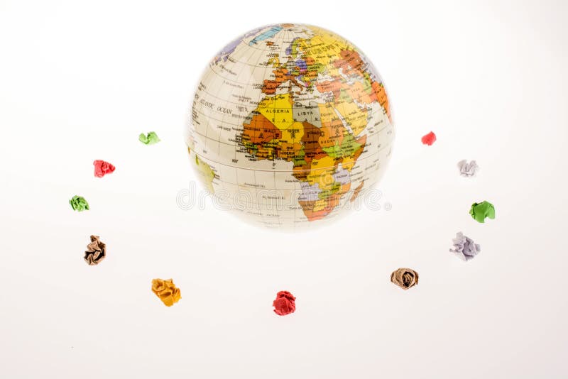 Crumpled papers form a round shape around a globe royalty free stock images