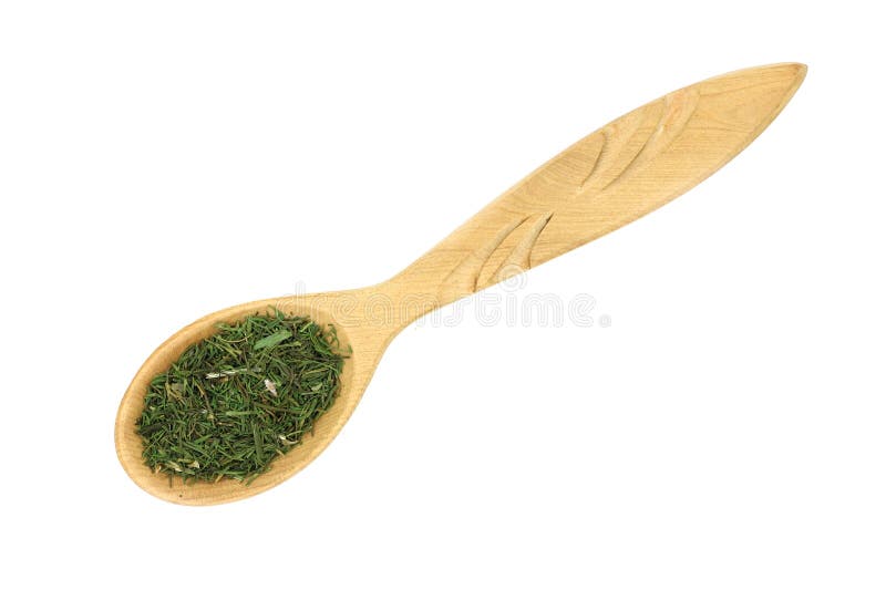 The crushed dried dill in a wooden spoon stock photos