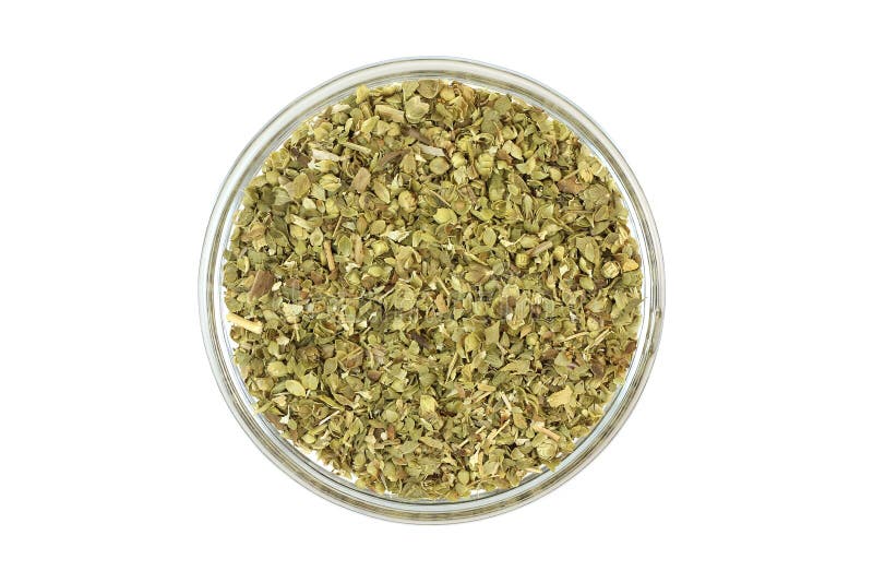 Crushed oregano leaves in a glass cup stock photography
