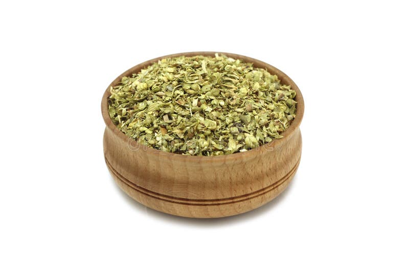 Crushed oregano leaves in a wooden dish royalty free stock images