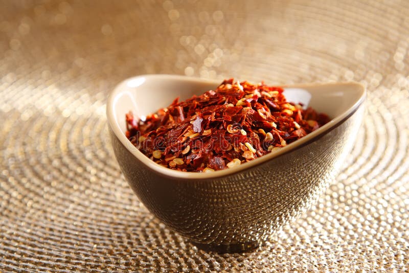 Crushed Red Hot Chilli Pepper In Bowl On Golden Picture. Image 6568740